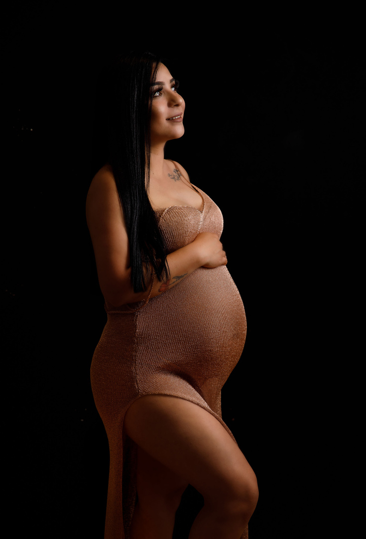 mom alone photoshoot taken in modesto ca at a downtown maternity studio. This beautiful photo was taken wearing a gold off the shoulder ARBackdrops silky see through gown that was hand made to be on trend with fine art pregnancy photography. 