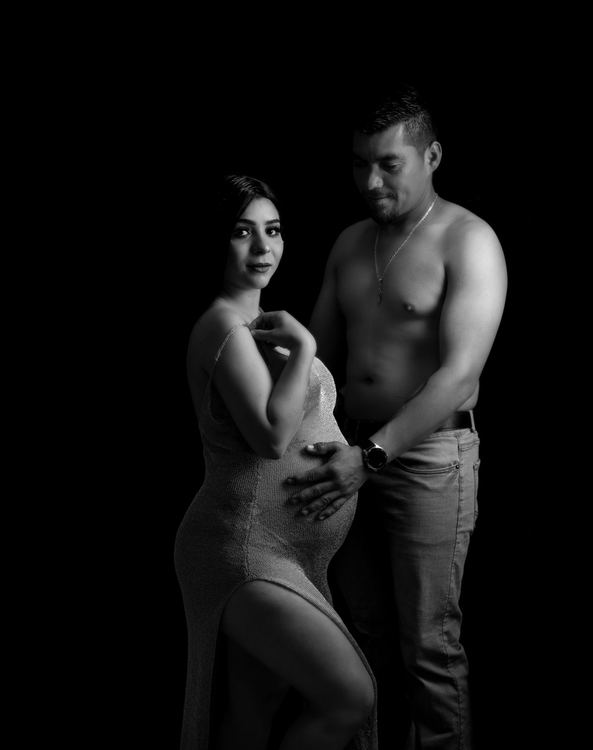 san Francisco California couple boudoir maternity photoshoot. This elegant shot was taken in a downtown photography. studio black and white monochromatic photography making for a dramatic image. Mom and dad during pregnancy is something to celebrate 