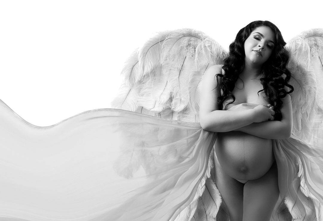 silk fairies maternity silk used to flow across and the homespun heart prop Victoria secret angel wings with a white backdrop clean fine art edited pregnancy photoshoot taken in Modesto California by Aly Incardona who specializes in prints and produc