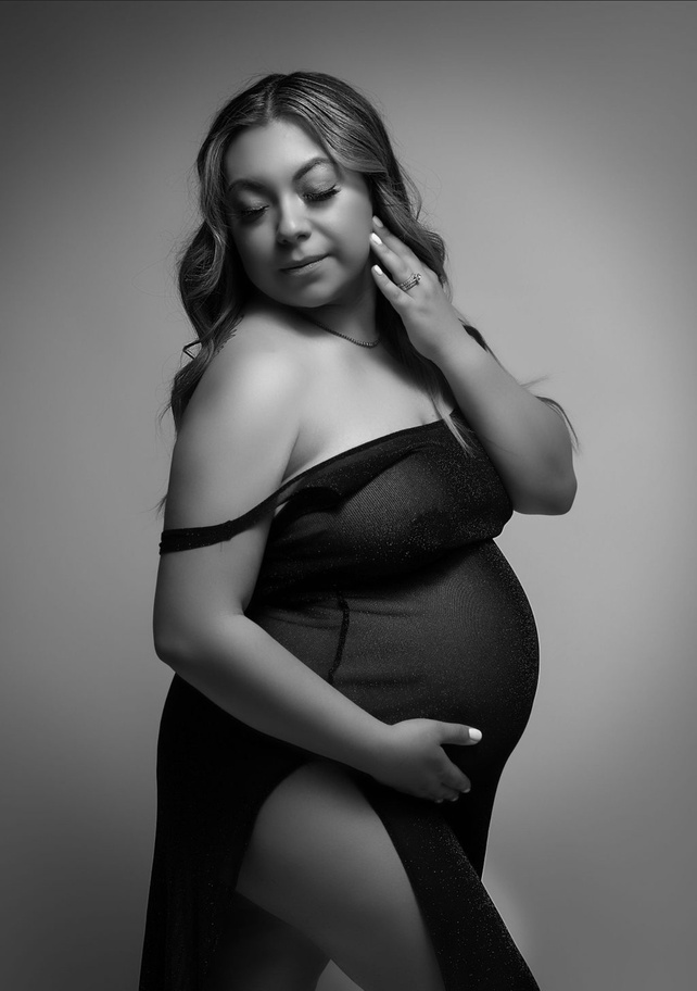 the best and most elegant and high fashion maternity photoshootin all of California. monochromatic maternity portraits are a way to capture timeless memories like this mother, 7 months pregnant in a beautiful black tulle gown off the shoulder pose
 